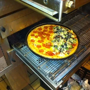 fresh pizza coming out of the oven