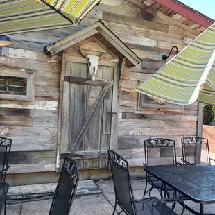 an outdoor dining area with tables and umbrellas