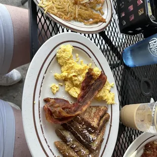 a breakfast of eggs, bacon, toast, and beans