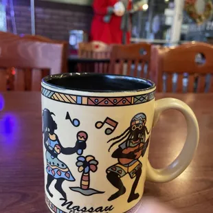a coffee cup with a scene on it