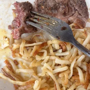 Raw steak and undercooked hash browns. Bummer breakfast.