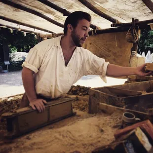 Justin provides visitor a brick to hold.