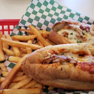 Delicious meatball parmigiana hero with melted mozzarella cheese and crispy french fries.