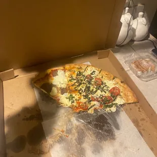 a half eaten pizza in a box