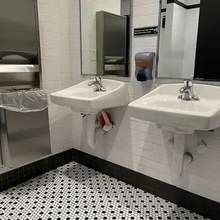 Men's bathroom sink view from the stall door