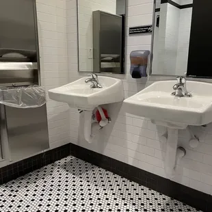 Men's bathroom sink view from the stall door