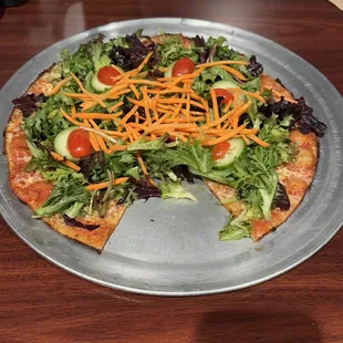 Pizza salad with tomato sauce and cheese.
