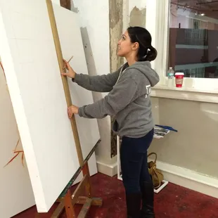 Artist Laudan doing the prep work on her new painting