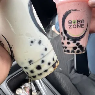 a hand holding a cup of bubble tea