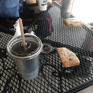 a cup of coffee and a sandwich on a table