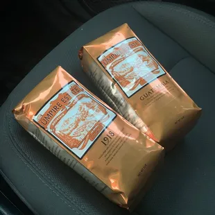 two bags of coffee on a car seat