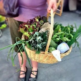 a woman carrying a basket of vegetables