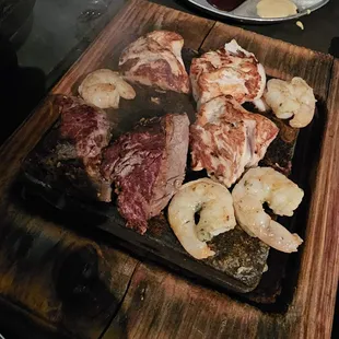 Cooking the meats on the stone