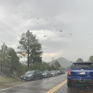 Cars parked outside of the Colorado Renaissance Festival due to lack of traffic control and parking.
