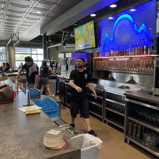 a man standing in front of the bar