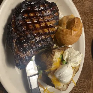 Single barrel pork loin with loaded potato and a dinner roll