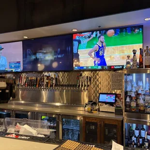 a bar with multiple televisions