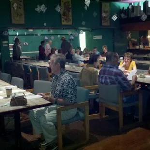 people sitting at tables in a restaurant