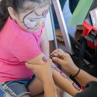 Face and body painting. She also did glitter tattoos.