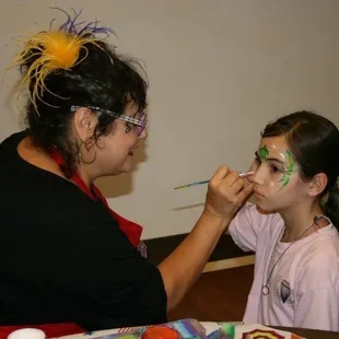 Face painter painting a child&apos;s face at a party!