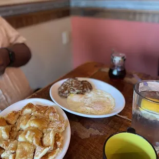 two plates of pancakes and a cup of tea