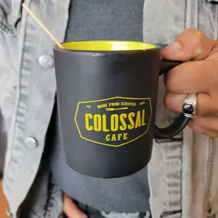 a person holding a coffee mug