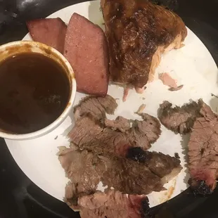 The thigh, some brisket and the sausage on my plate with the bbq sauce. I tried one bite of each. Disgusting.