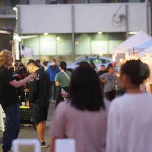 people walking around a food truck