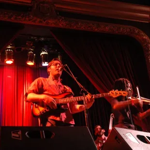 a man playing guitar on stage