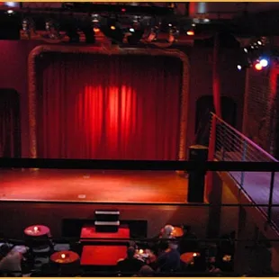 a stage with a red curtain