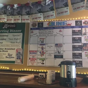 Monthly schedule with specials on the wall.