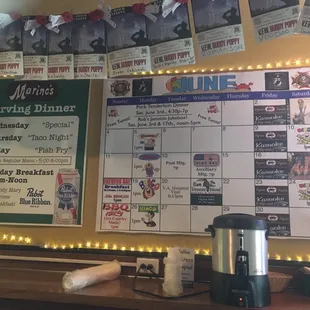 Monthly schedule with specials on the wall.