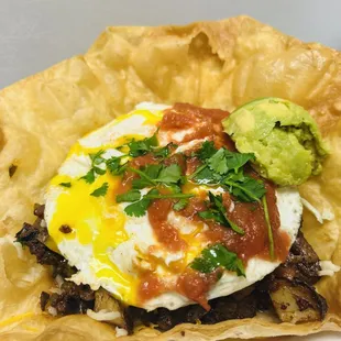 a burrito with an egg and guacamole