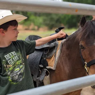Grandson loving on Poncho after his ride