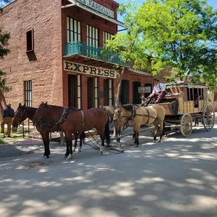 The stagecoach parked in front of the Wells Fargo Express office.  Can you get any more old west town iconic than that?