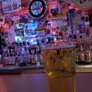 a pint of beer on a bar counter