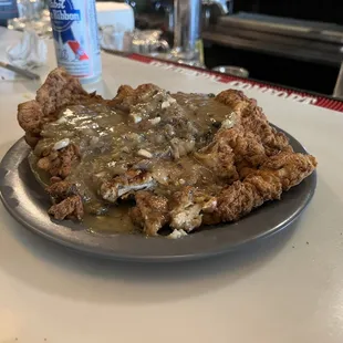 a plate of meat and gravy