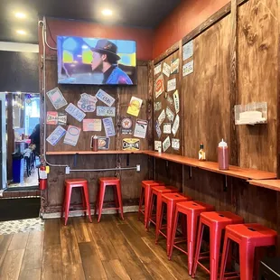 a bar with red stools