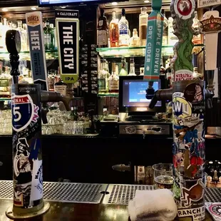 a bar with beer taps and a television