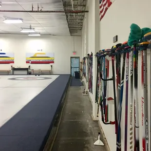 Club brooms for visitors, and personal brooms stored for members.
