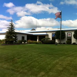 the front of a building with an american flag in front of it