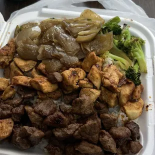 Chicken and steak hibachi with onions broccoli and zucchini with steamed rice