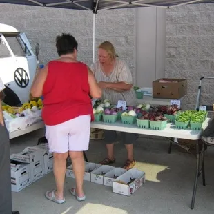 a woman buying vegetables