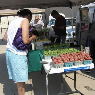 a woman buying vegetables