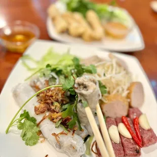 Bánh Cuon, steamed rice roll, stuffed with grounded pork &amp; mushroom, fried shallot, fresh herbs, bean sprout, ham topping, and more