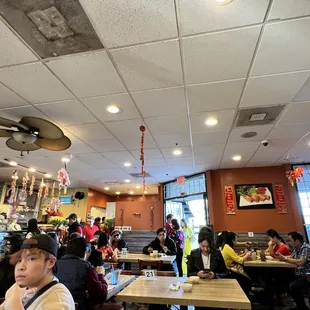 people sitting at tables in a restaurant