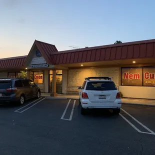 two cars parked in front of a restaurant