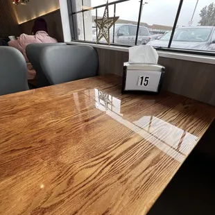 Clean table 15 looking out into the parking lot. Very nice shiny table and cushy chairs.