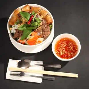 a bowl of food and chopsticks