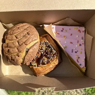 Choco Chunk Concha (L), Imelda's Mole Calabaza Croissant (C), Pink Cake (R)